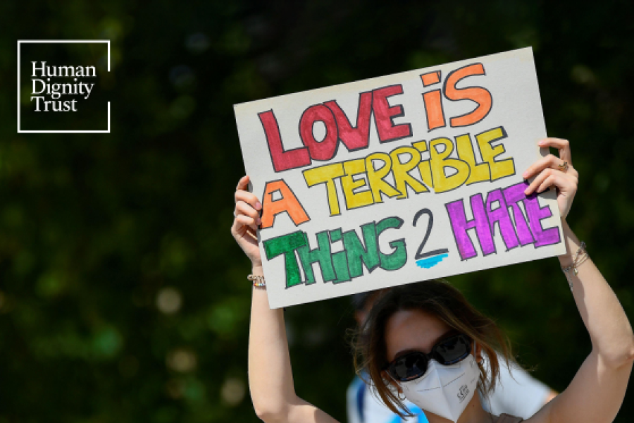 Screenshot showing the cover page of the resource, including the human dignity trust logo, title and person holding up a ‘love is a terrible thing to hate’ poster. 